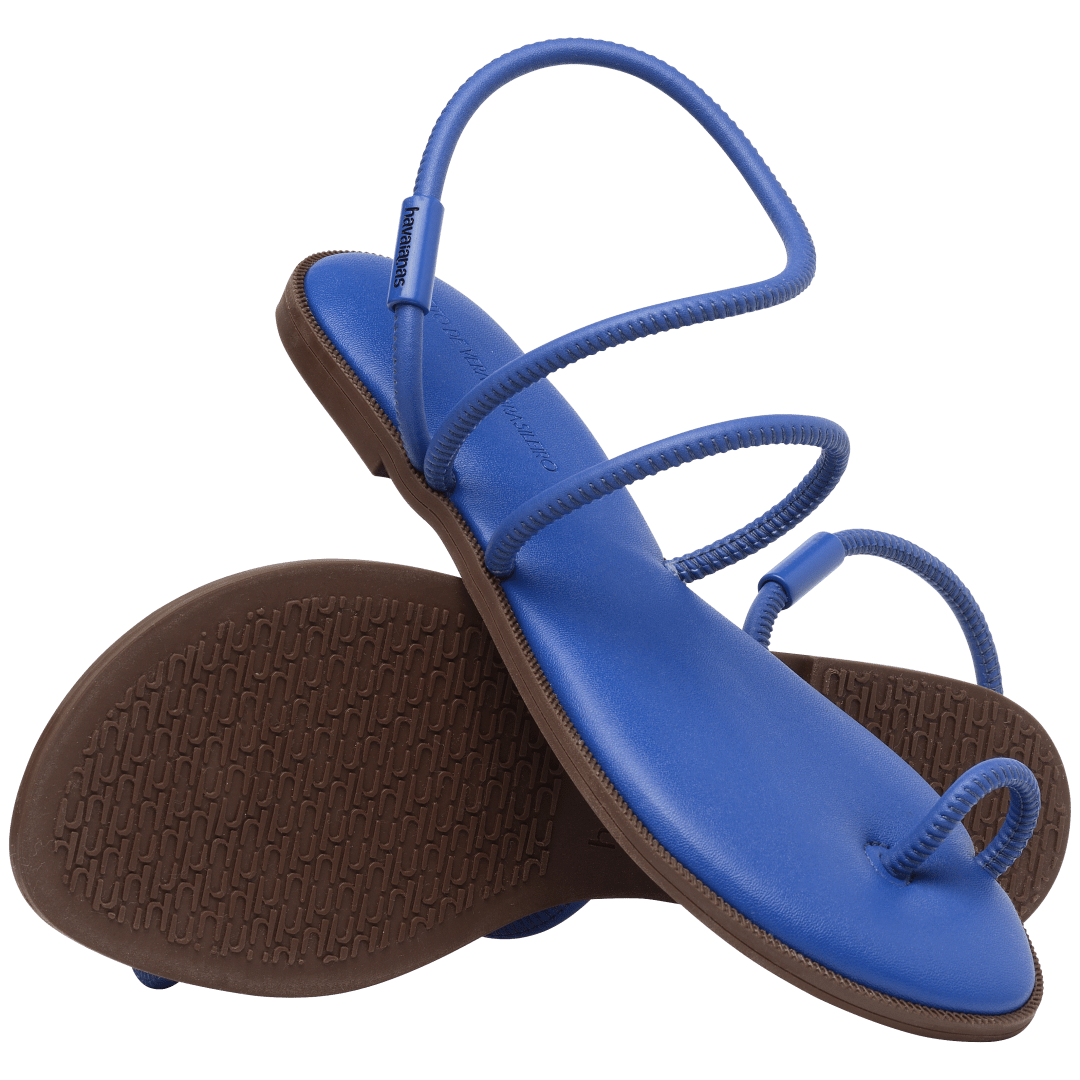 Women's cobalt blue strappy sandal bottom view of brown sole and top view with sandal perched