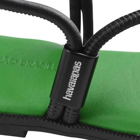 Women's green sole sandal with black straps logo detail view