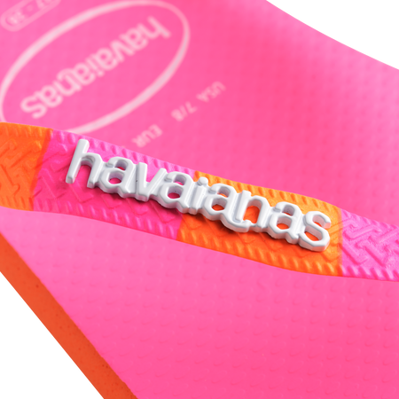 Women's neon pink flip flop with orange and pink striped straps logo detail