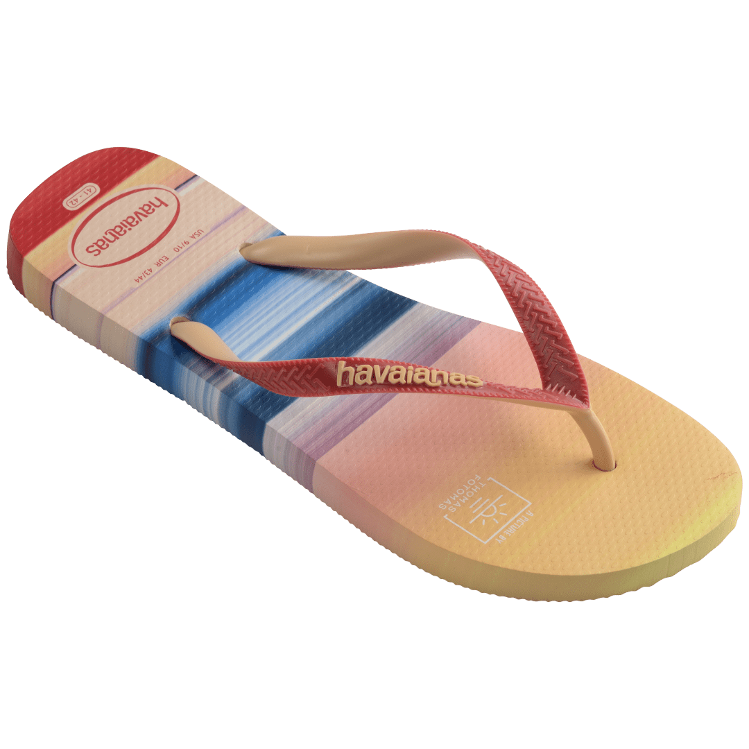 Multicolor flip flop with sunset horizon view over the ocean featuring a surfer right 3/4 view