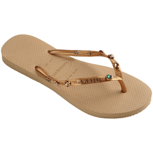 Women's tan flip flops with gold metallic straps featuring multicolor crystals right foot 3/4 view