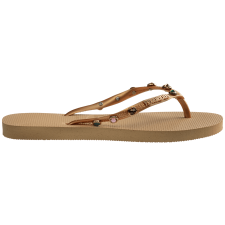 Women's tan flip flops with gold metallic straps featuring multicolor crystals side view