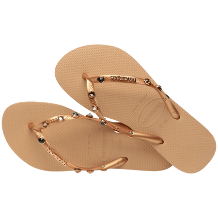 Women's tan flip flops with gold metallic straps featuring multicolor crystals alternate top view