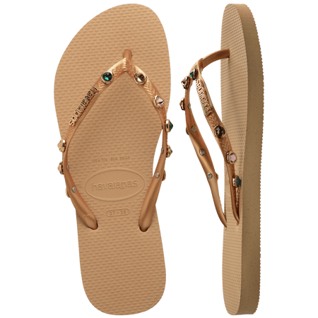 Women's tan flip flops with gold metallic straps featuring multicolor crystals top and side view