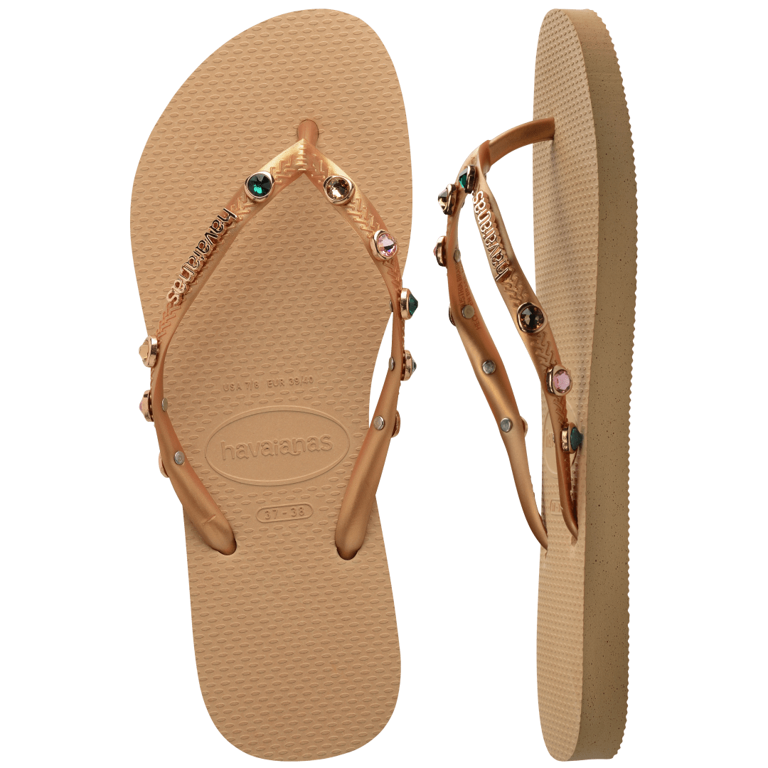 Women's tan flip flops with gold metallic straps featuring multicolor crystals top and side view