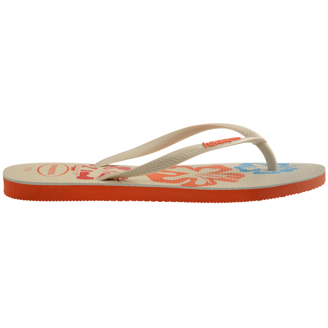 Women's cream flip flop with blue, orange and red flowers and orange printed Hawaii on the left foot side view showing orange sole