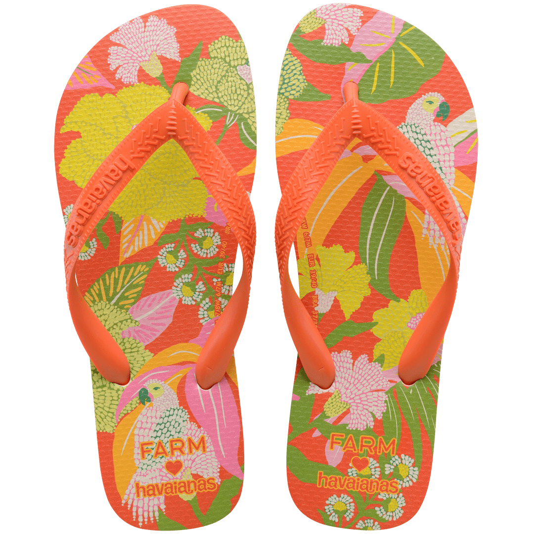 Women's FARM Rio x Havaianas orange, pink, yellow and green print flip flops with flowers, parrots and plants and orange straps top view