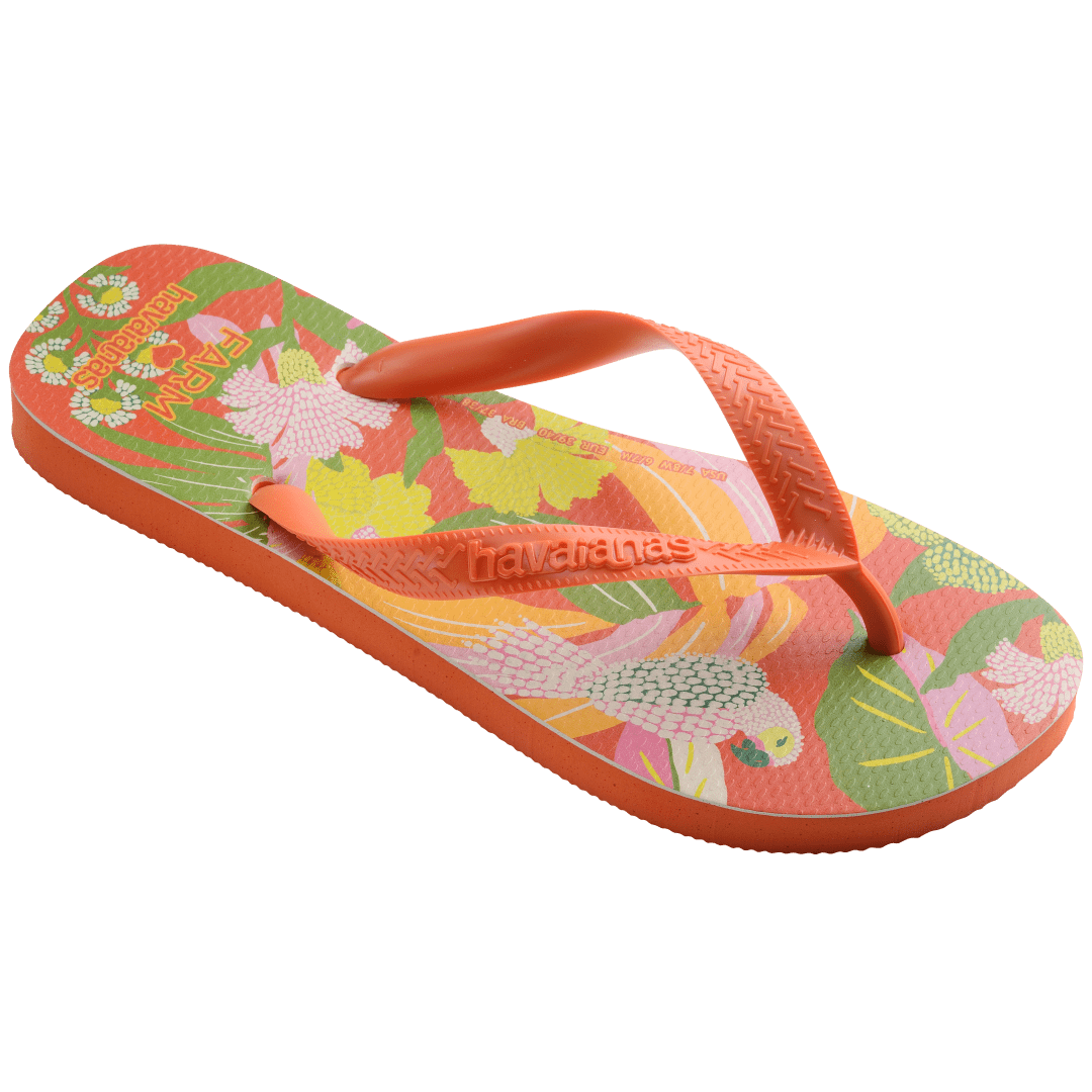 Women's FARM Rio x Havaianas orange, pink, yellow and green print flip flops with flowers, parrots and plants and orange straps 3/4 side view