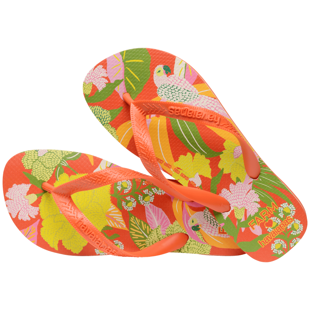 Women's FARM Rio x Havaianas orange, pink, yellow and green print flip flops with flowers, parrots and plants and orange straps alternate top view