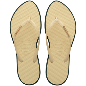 Women's cream pointed toe flip flops with dark green contrast sole top view