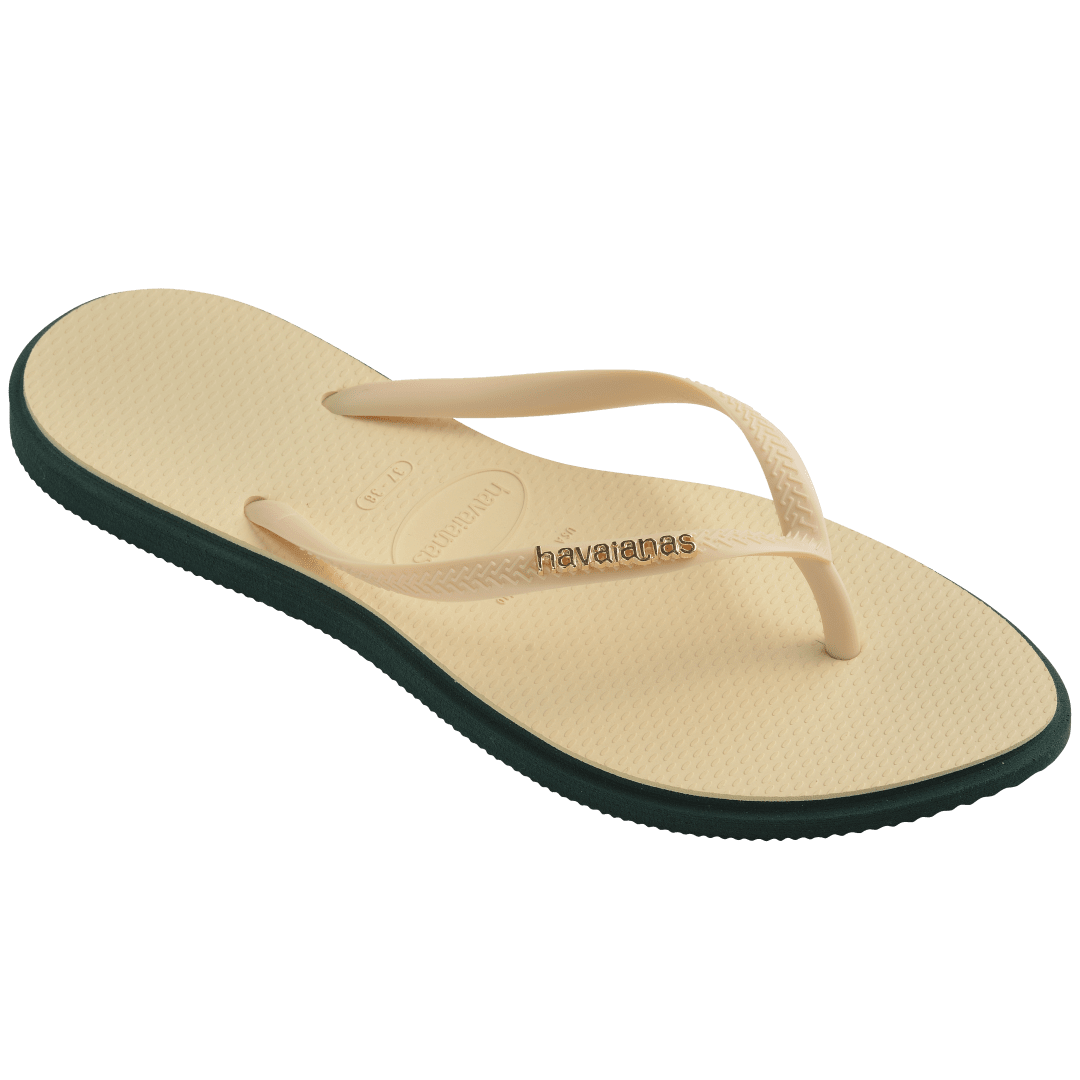 Women's cream pointed toe flip flops with dark green contrast sole 3/4 side view