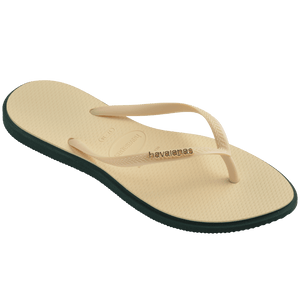 Women's cream pointed toe flip flops with dark green contrast sole 3/4 side view