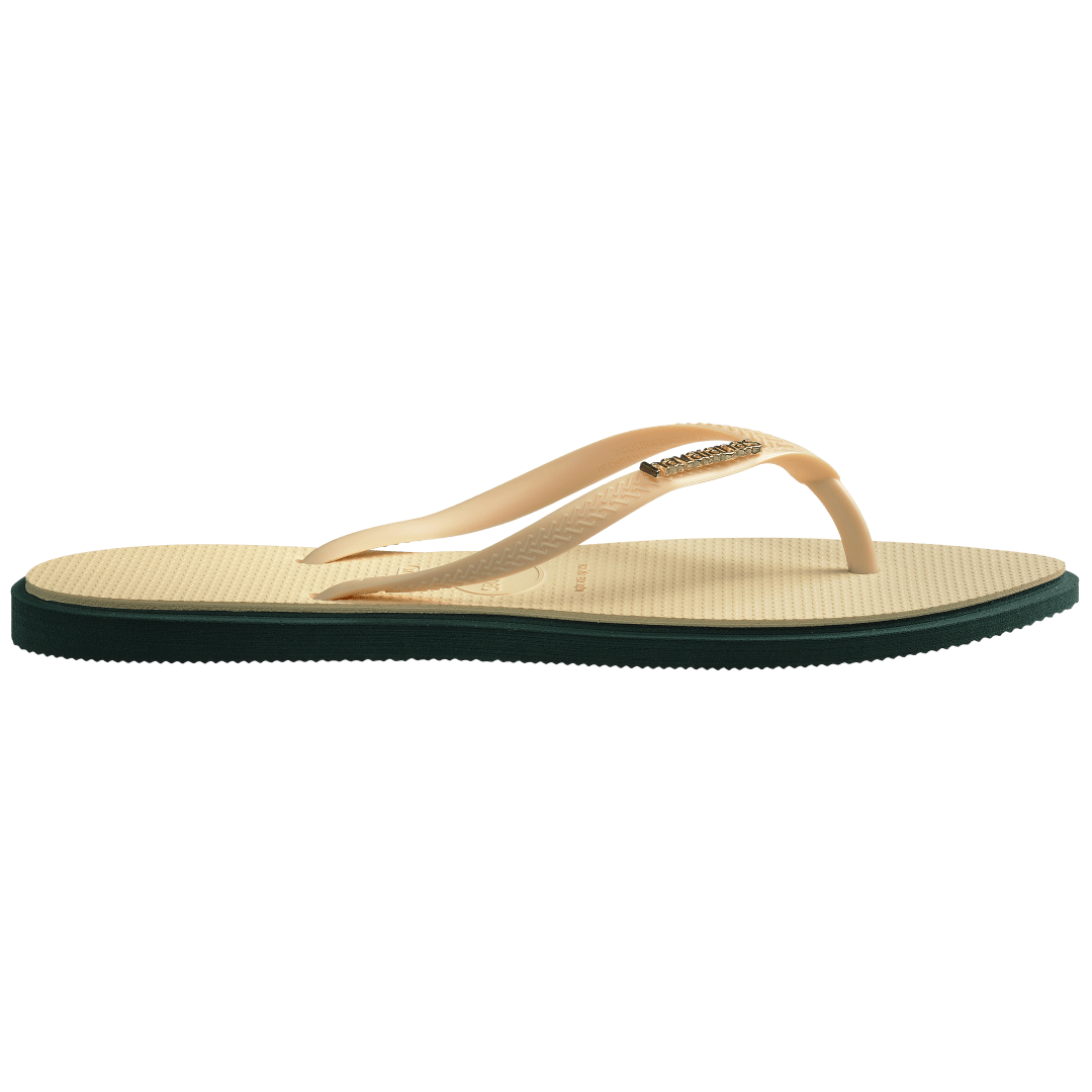 Women's cream pointed toe flip flops with dark green contrast sole side view