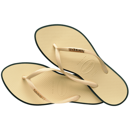 Women's cream pointed toe flip flops with dark green contrast sole alternate top view