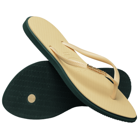 Women's cream pointed toe flip flops with dark green contrast sole, right shoe perched on left