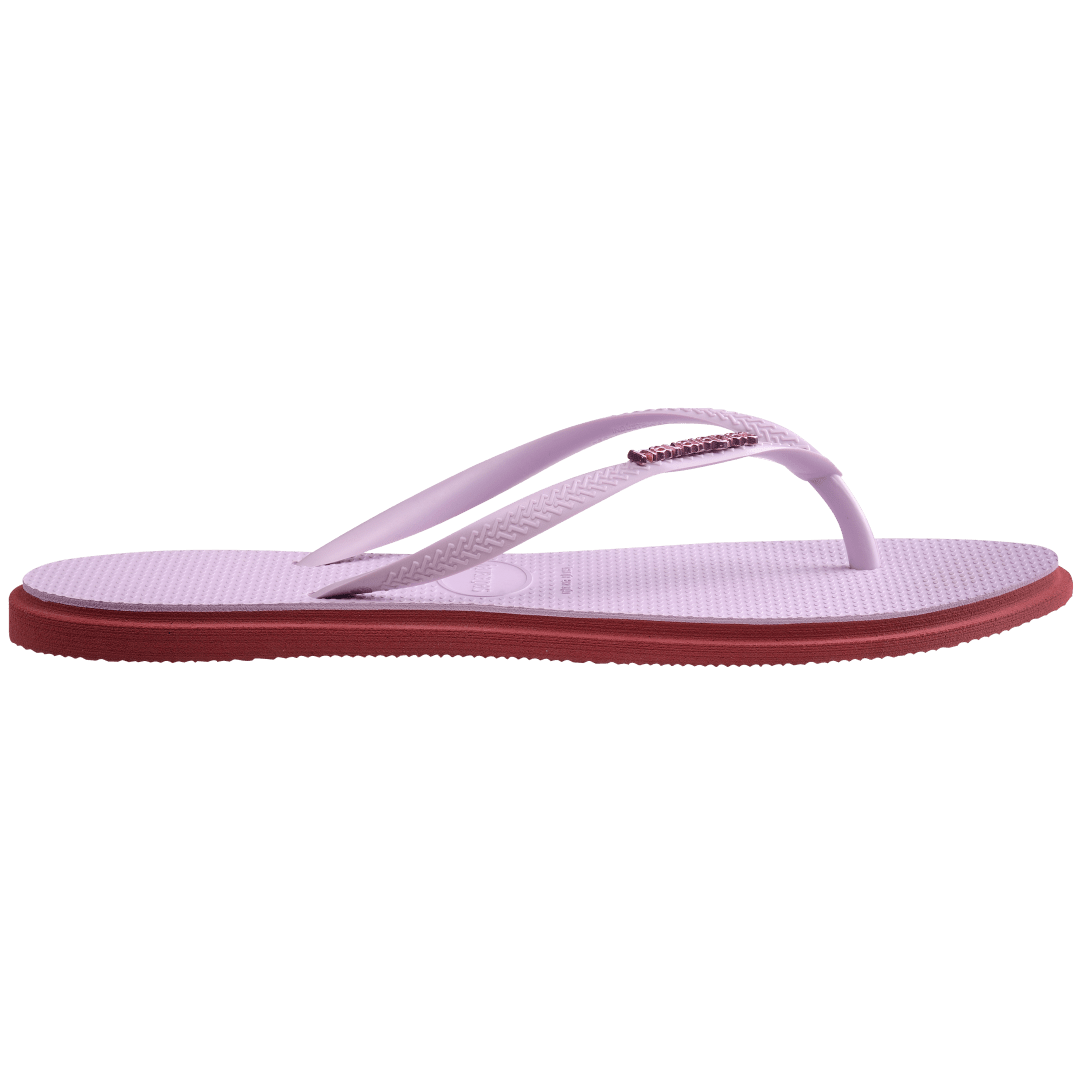 Women's light purple pointed toe flip flops with red contrast sole, side view