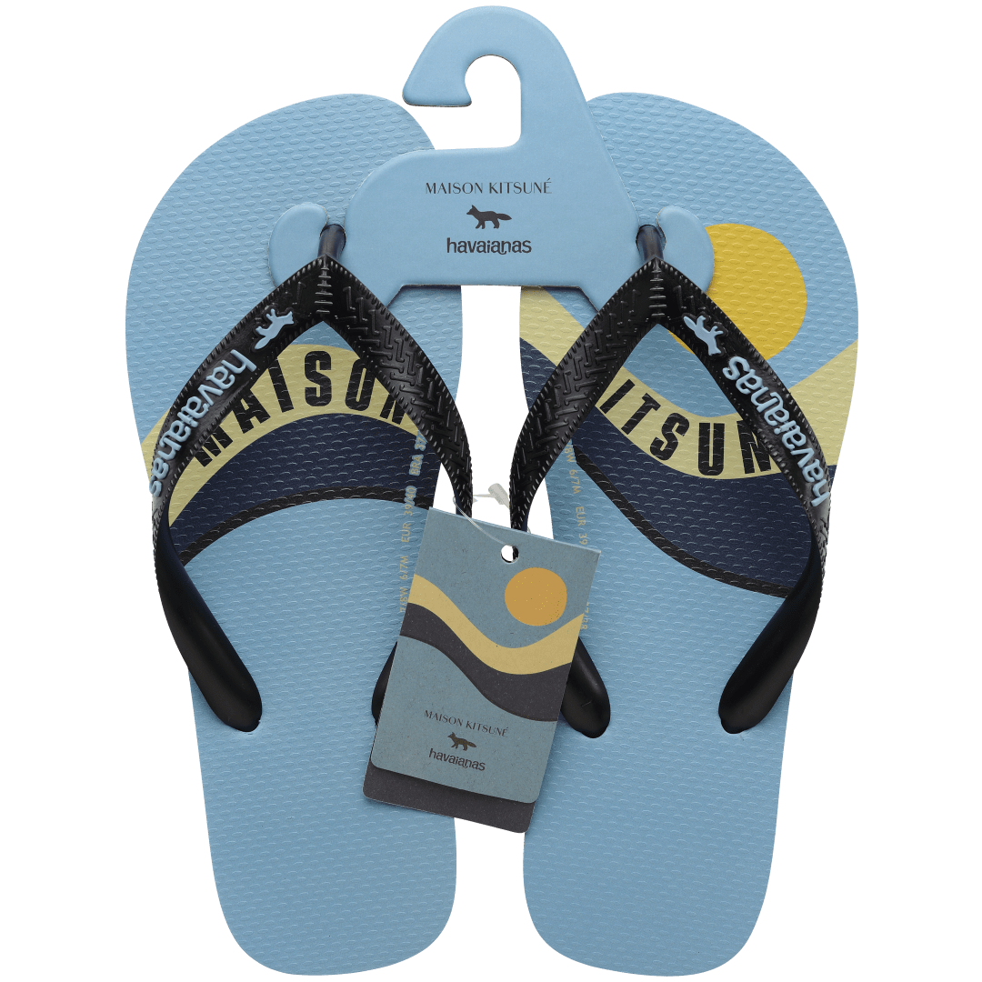 Unisex Maison Kitsune x Havaianas light blue flip flop with wave print and black straps, top view with packaging