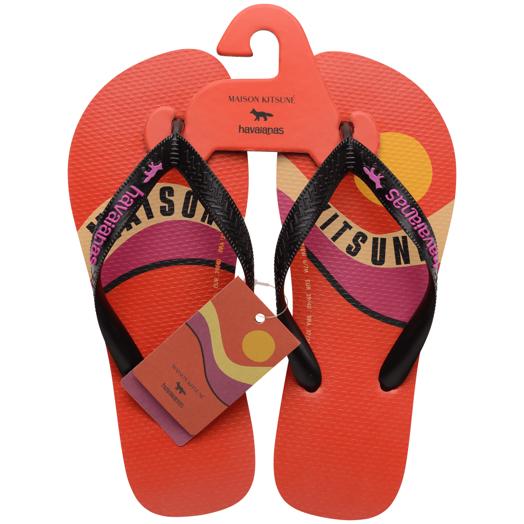 Unisex Maison Kitsune x Havaianas red flip flop with pink, yellow and tan wave print and black straps, top view with packaging