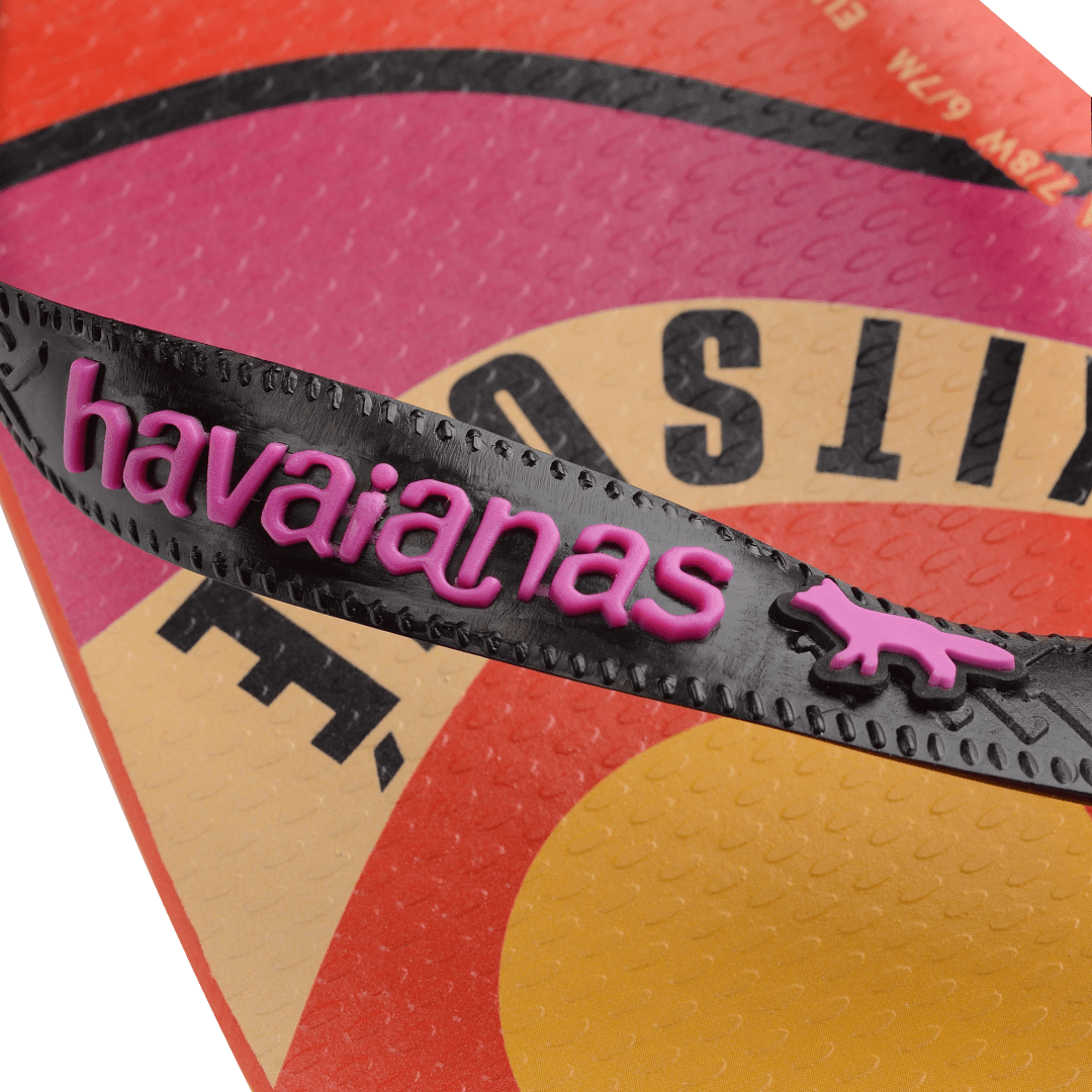 Unisex Maison Kitsune x Havaianas red flip flop with pink, yellow and tan wave print and black straps, detail view