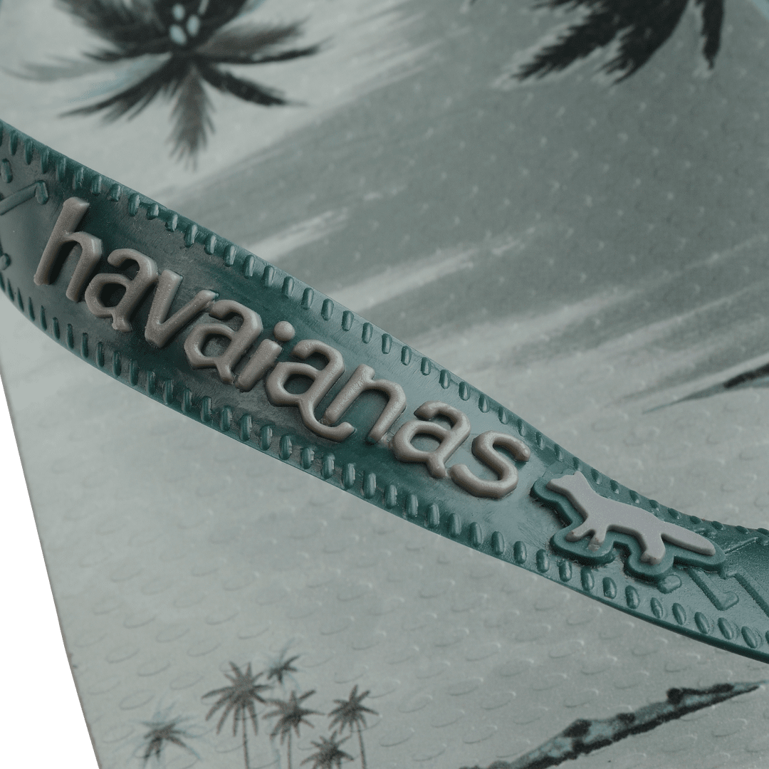 Maison Kitsune x Havaianas teal tonal tropical print flip flops with dark green straps, detail view