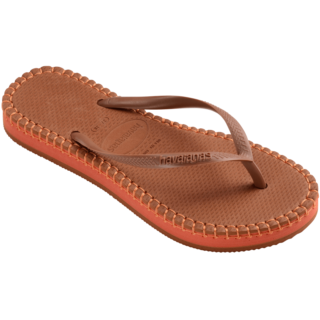 brown flip flops with orange stitching around the sole, and orange midlayer between the sole and bottom of shoe, top right view