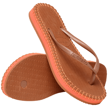 brown flip flops with orange stitching around the sole, and orange midlayer between the sole and bottom of shoe, one sandal leaning on the other sandal, with toe side down