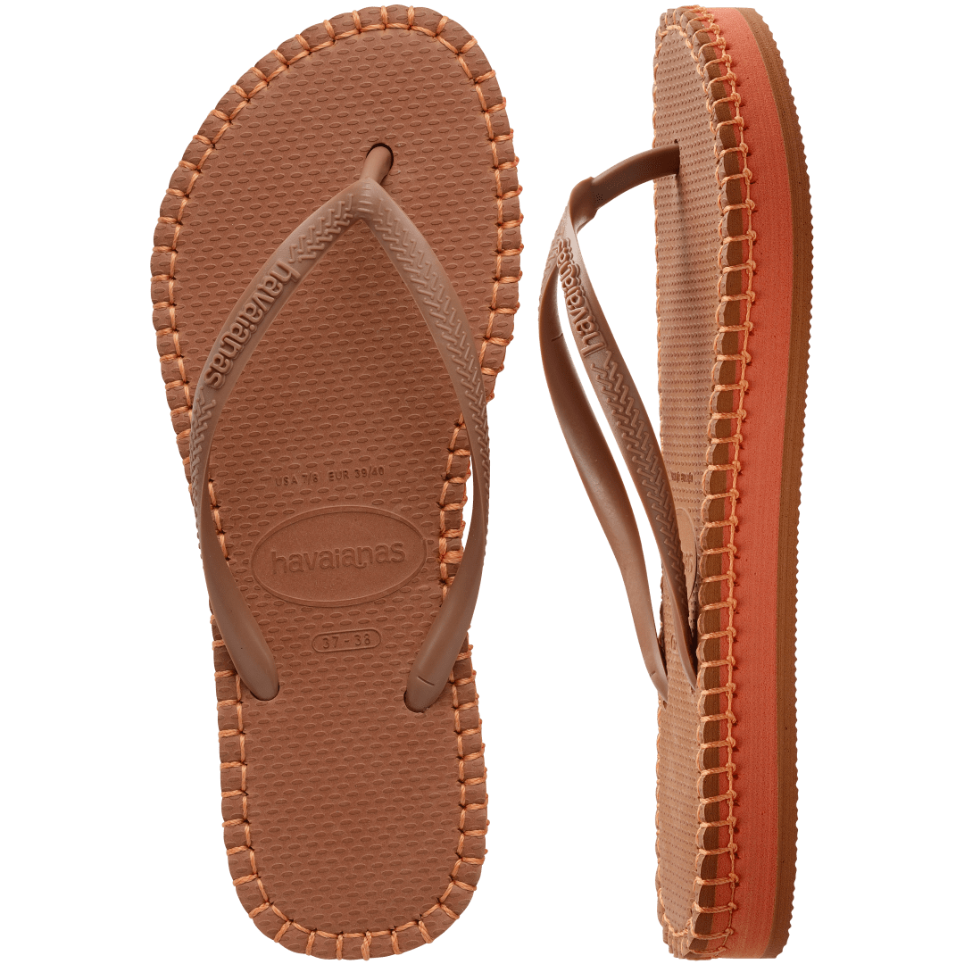 brown flip flops with orange stitching around the sole, and orange midlayer between the sole and bottom of shoe, one sandal top view and one sandal side view