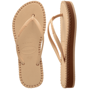 beige sandal with darker brown stitching and a dark brown midlayer between the sole and bottom of shoe, one sandal top view, one sandal side view