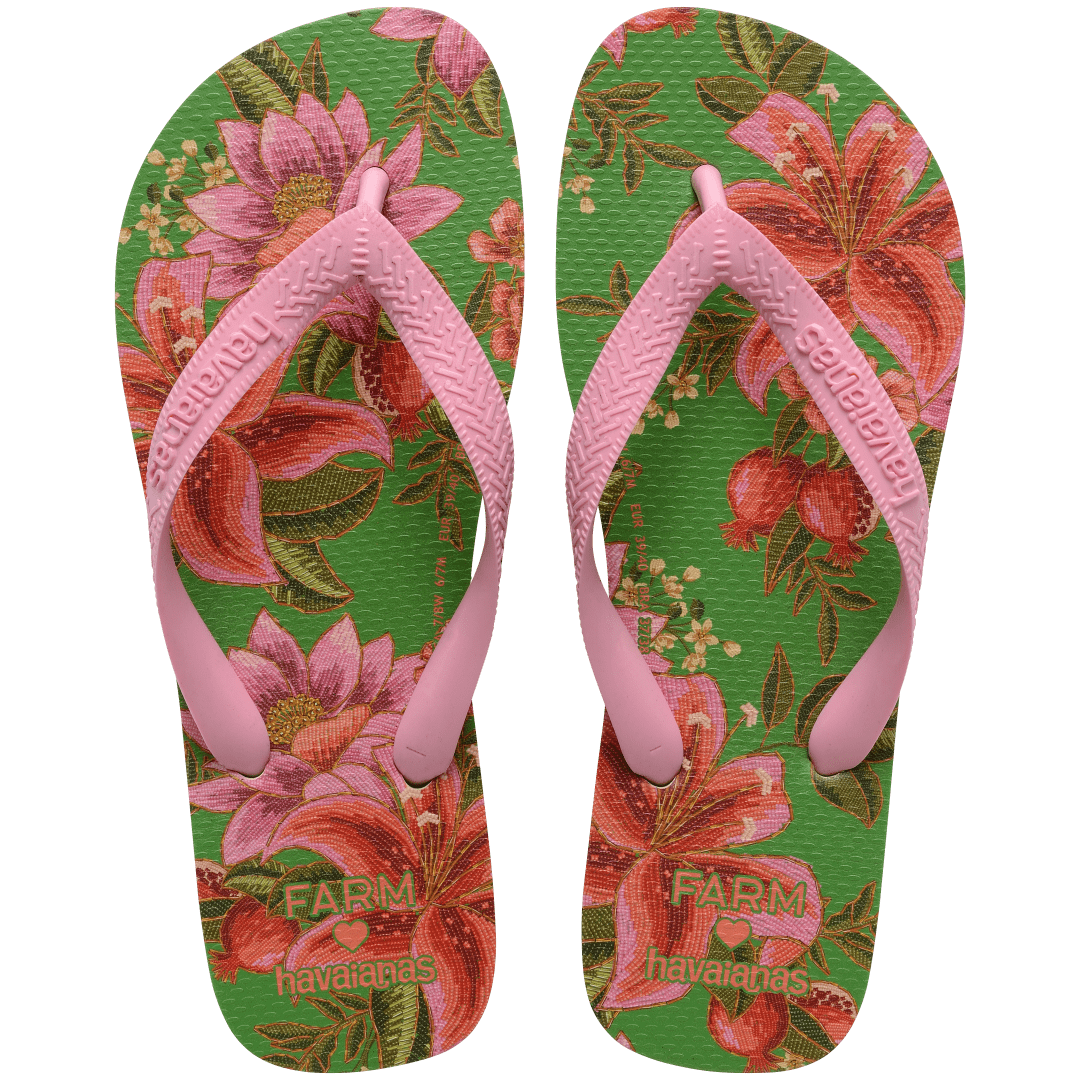 flip flops with green sole featuring pink flowers and pink straps, top facing