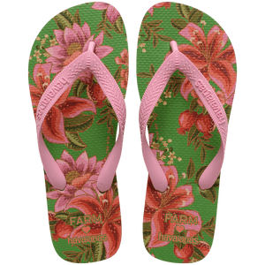 flip flops with green sole featuring pink flowers and pink straps, top facing