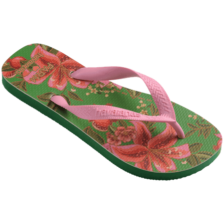 flip flops with green sole featuring pink flowers and pink straps, front diagonal facing