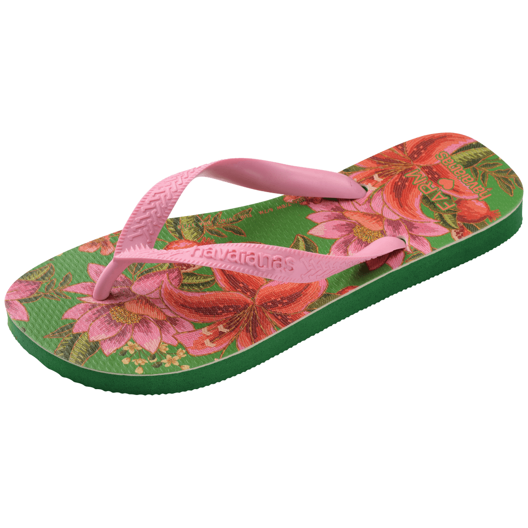 flip flops with green sole featuring pink flowers and pink straps, front-side facing