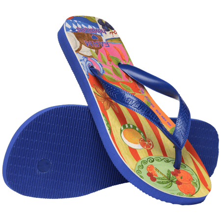 flip flops with fruit on a multicolor background with blue straps, one standing up on it's toe, diagonal resting on the other flip flop