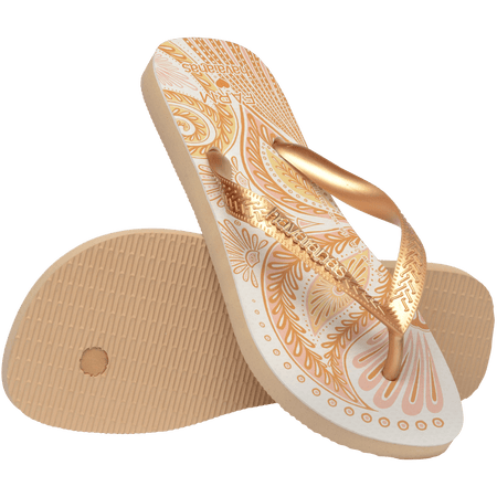 flip flops with gold and light pink abstract print and metallic gold straps with a metal havaianas logo, one flip flop resting on the other flip flop, toe side facing down