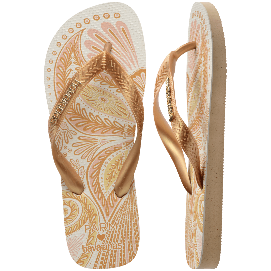 flip flops with gold and light pink abstract print and metallic gold straps with a metal havaianas logo, one flip flop top facing and one on its side