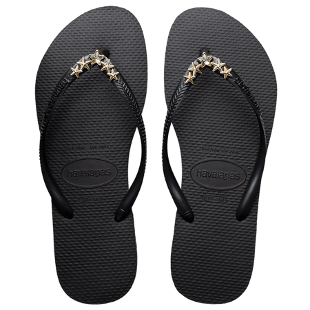 Women's black flip flops with gold star charm embellishment, top view