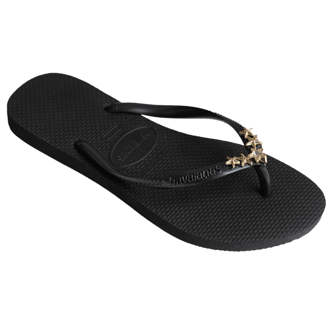 Women's black flip flops with gold star charm embellishment, right 3/4 view