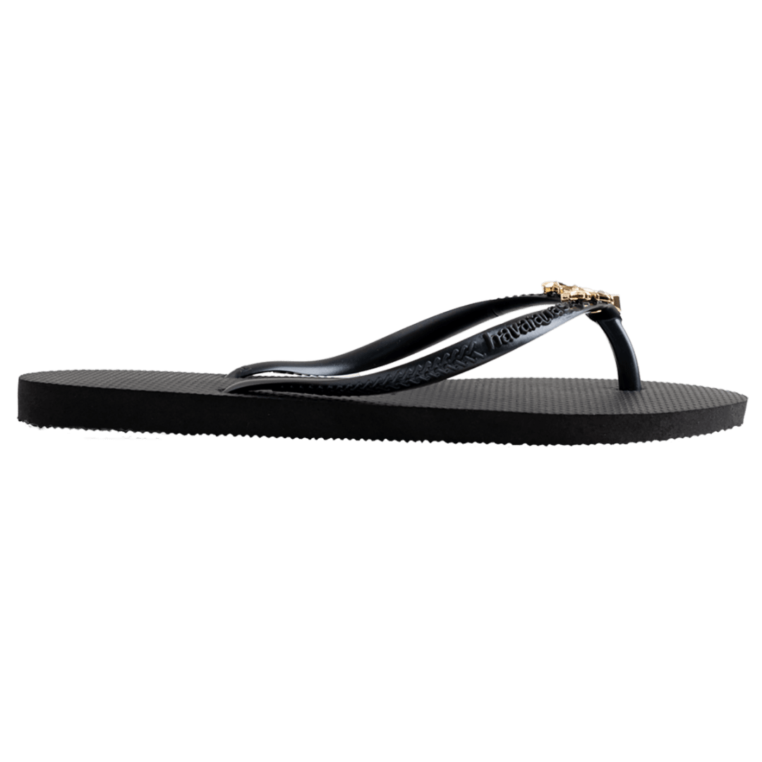 Women's black flip flops with gold star charm embellishment, side view